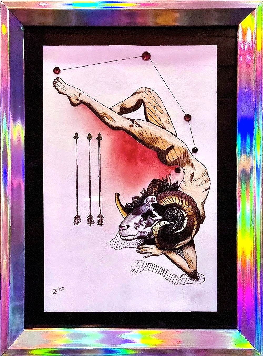 A framed art print featuring a stylized illustration of a nude figure with a ram's head, connected to constellation dots, with three arrows on a pale pink background. The print is housed in a thick black frame with a highly reflective, iridescent holographic border that displays rainbow colors.