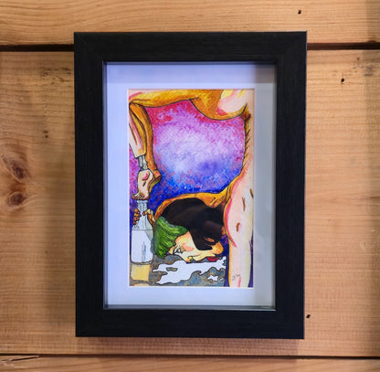Framed artwork of a colorful abstract design on a wooden surface