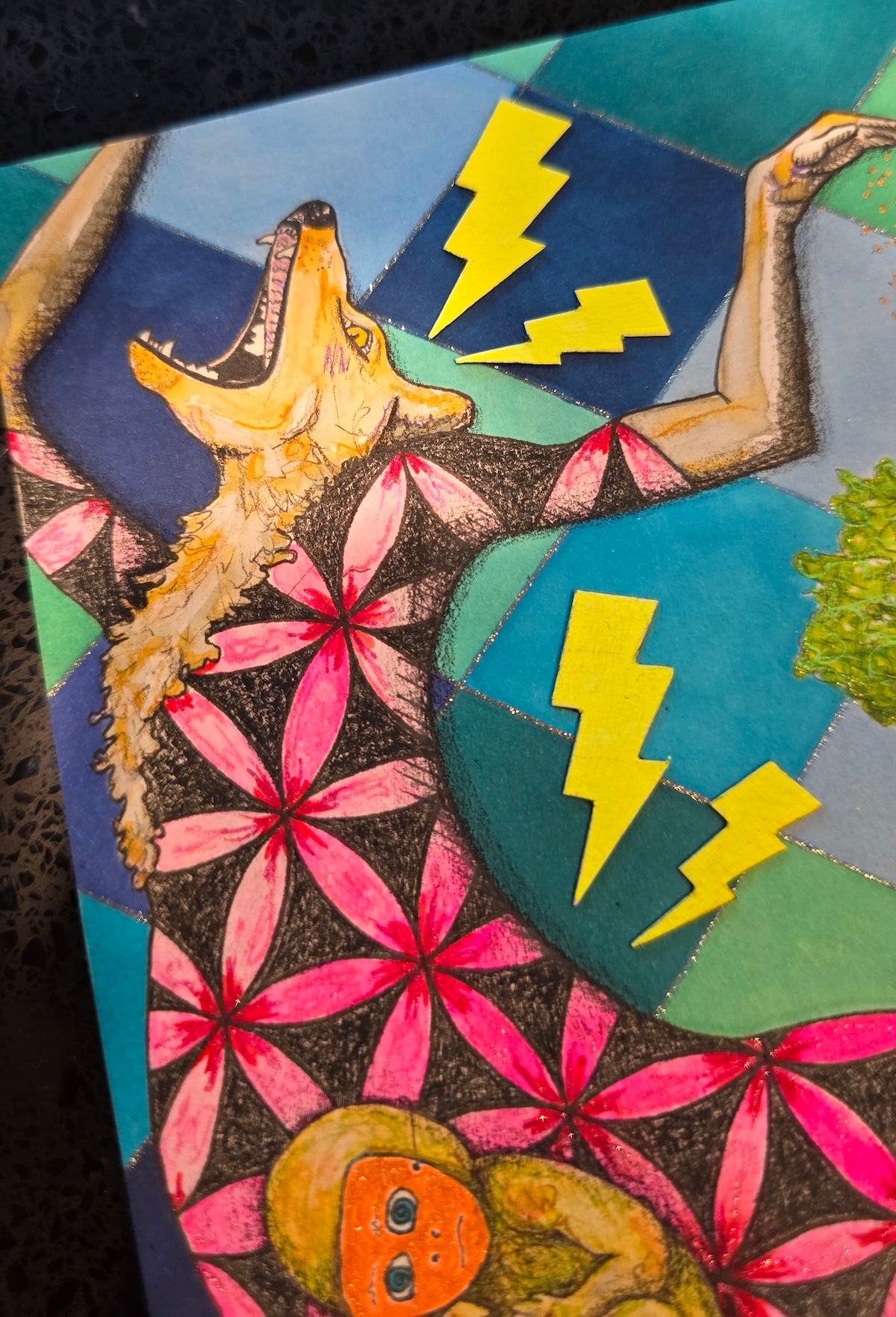 A close-up of a colorful mixed-media artwork depicting a stylized figure with a wolf head, pink geometric flower patterns, yellow lightning bolts, and blue and green shapes.